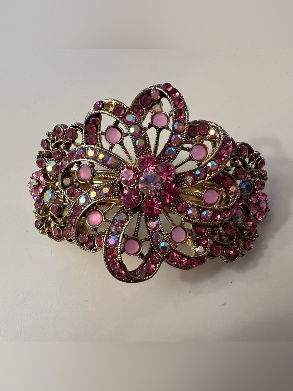 Vintage gold tone hair barrette w/ pink rhinestones in a floral design